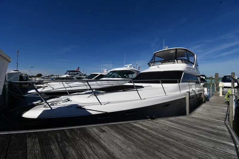 Nina Yacht Photos Pics 2002 Sea Ray 480 Sedan Bridge yacht docked at marina under clear blue sky.