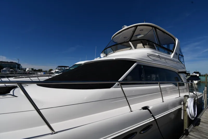 Nina Yacht Photos Pics 2002 Sea Ray 480 Sedan Bridge yacht docked under clear blue sky.