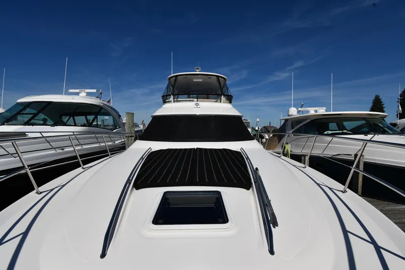 Nina Yacht Photos Pics 2002 Sea Ray 480 Sedan Bridge yacht docked under clear blue sky.