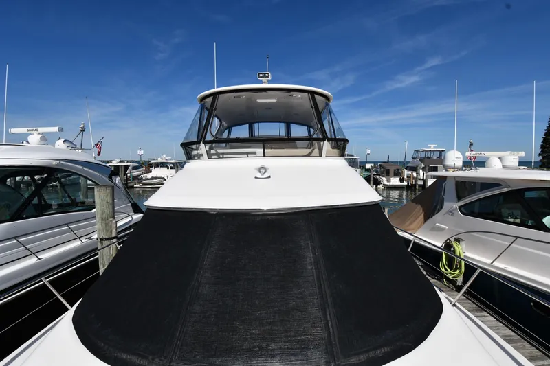 Nina Yacht Photos Pics 2002 Sea Ray 480 Sedan Bridge yacht docked at marina under clear blue sky.