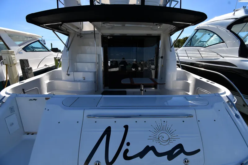 Nina Yacht Photos Pics 2002 Sea Ray 480 Sedan Bridge yacht docked, featuring spacious deck and elegant design.