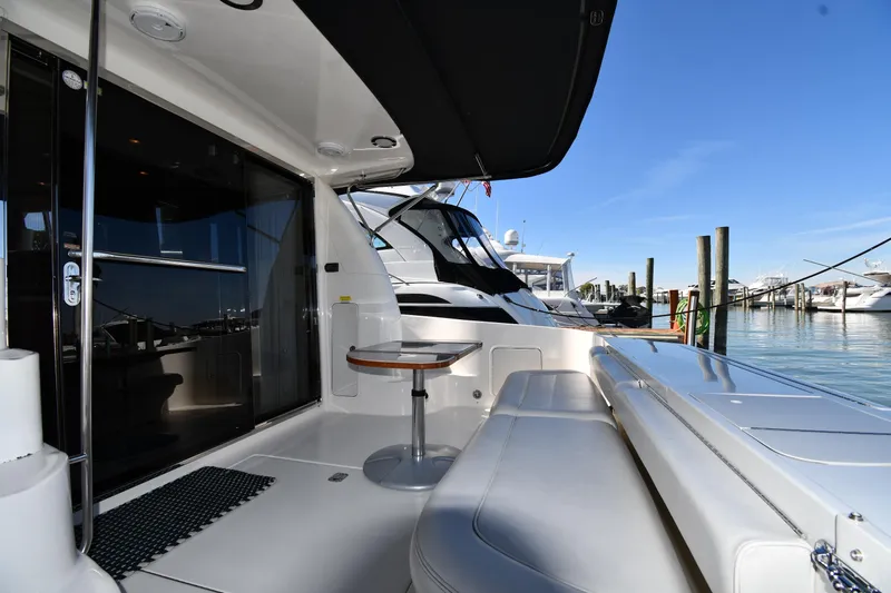 Nina Yacht Photos Pics 2002 Sea Ray 480 Sedan Bridge yacht with sleek deck and marina view.