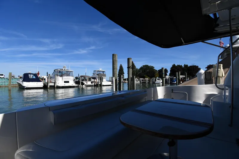 Nina Yacht Photos Pics 2002 Sea Ray 480 Sedan Bridge yacht docked at marina under clear blue sky.