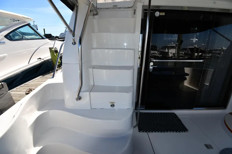 Nina Yacht Photos Pics 2002 Sea Ray 480 Sedan Bridge yacht with sleek white stairs and glass door.