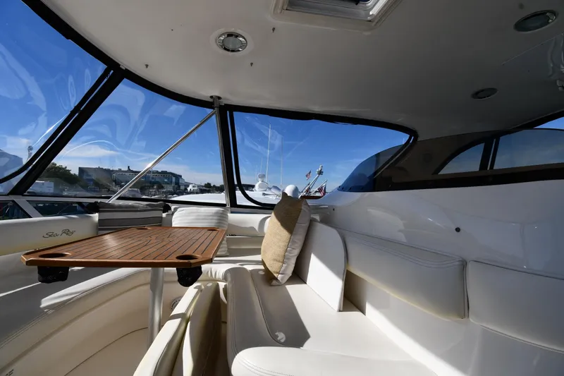 Nina Yacht Photos Pics Luxurious interior of 2002 Sea Ray 480 Sedan Bridge yacht with elegant seating and table.