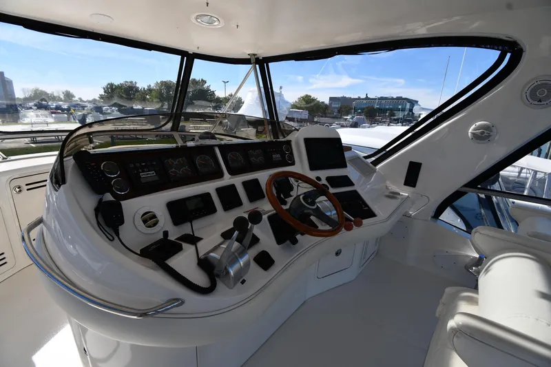 Nina Yacht Photos Pics 2002 Sea Ray 480 Sedan Bridge helm with modern controls and panoramic view.