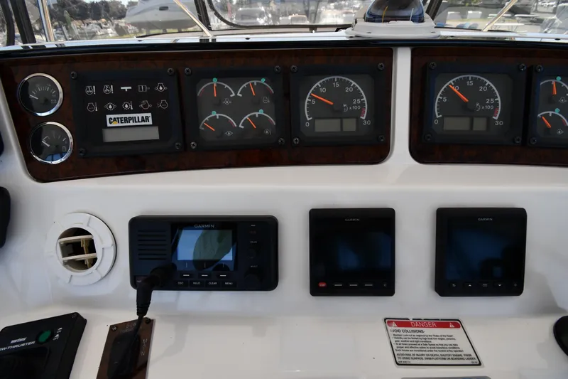Nina Yacht Photos Pics Control panel of a 2002 Sea Ray 480 Sedan Bridge with gauges and Garmin displays.