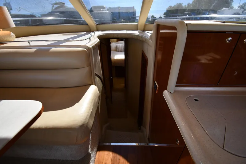 Nina Yacht Photos Pics Interior of 2002 Sea Ray 480 Sedan Bridge yacht, featuring luxurious seating and cabinetry.