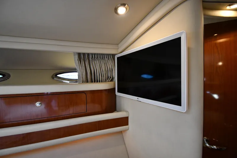 Nina Yacht Photos Pics Interior of 2002 Sea Ray 480 Sedan Bridge with mounted TV and wood cabinetry.