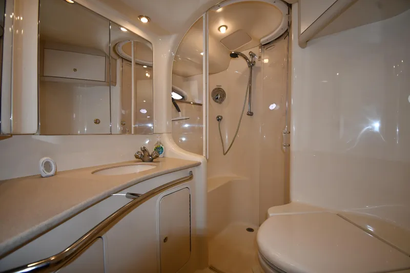 Nina Yacht Photos Pics Luxurious bathroom in 2002 Sea Ray 480 Sedan Bridge yacht, featuring shower and vanity.