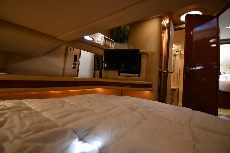 Nina Yacht Photos Pics Luxurious interior of 2002 Sea Ray 480 Sedan Bridge yacht with cozy bedroom and TV.