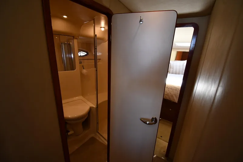 Nina Yacht Photos Pics Bathroom interior of 2002 Sea Ray 480 Sedan Bridge yacht, featuring shower and toilet.