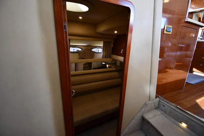 Nina Yacht Photos Pics Interior cabin of 2002 Sea Ray 480 Sedan Bridge yacht, featuring cozy seating and wooden finishes.