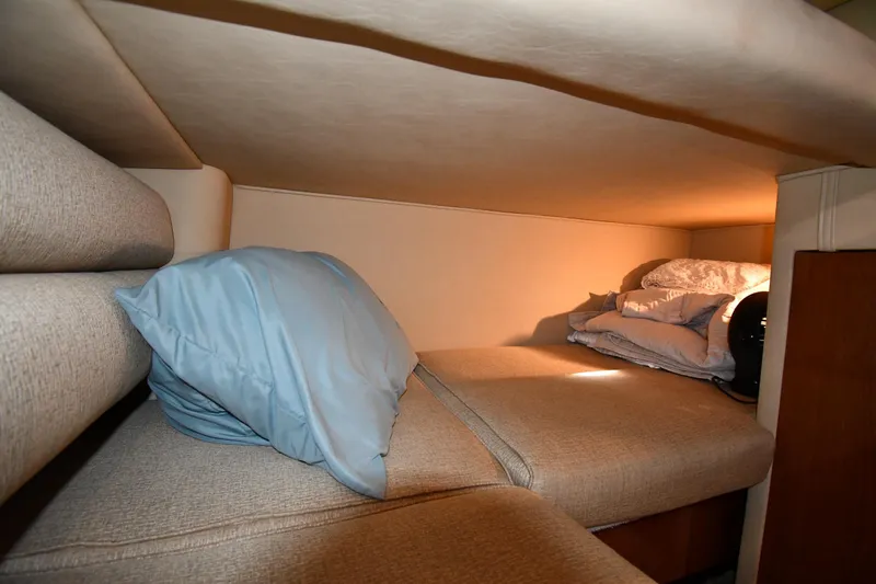 Nina Yacht Photos Pics Cozy cabin interior of 2002 Sea Ray 480 Sedan Bridge with bedding and cushions.
