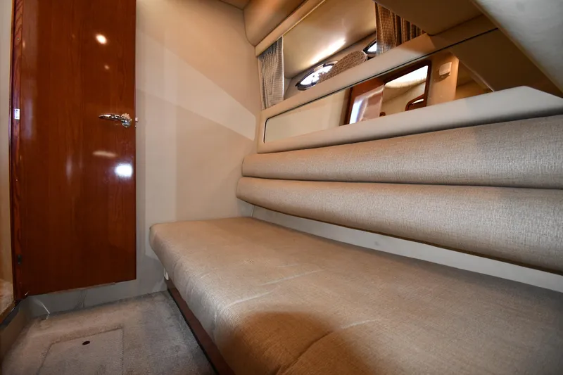 Nina Yacht Photos Pics Interior cabin of 2002 Sea Ray 480 Sedan Bridge with beige seating and wooden door.