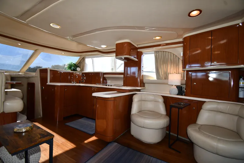 Nina Yacht Photos Pics Luxurious interior of 2002 Sea Ray 480 Sedan Bridge yacht with elegant wood finishes.