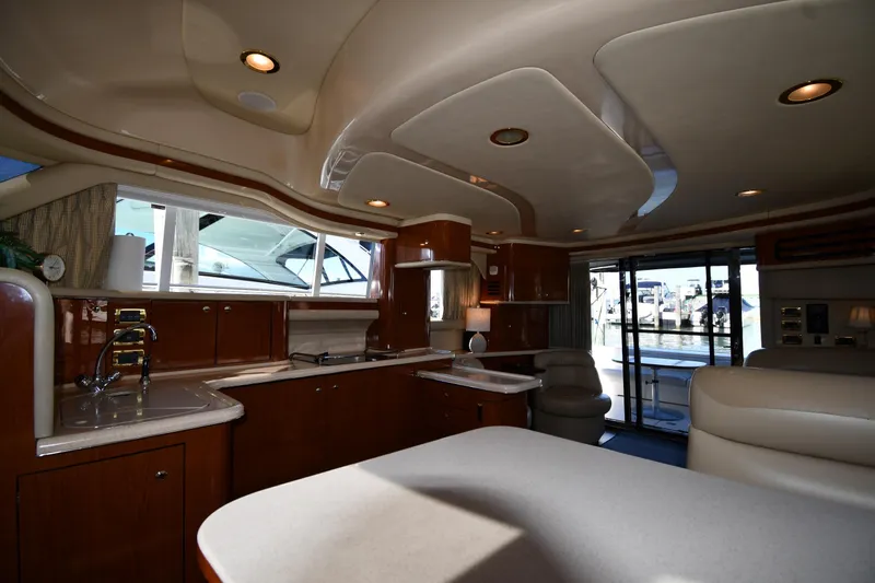 Nina Yacht Photos Pics Luxurious interior of 2002 Sea Ray 480 Sedan Bridge yacht with modern kitchen amenities.