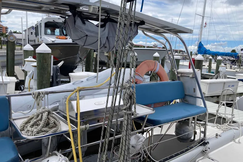 Stimulus Package Yacht Photos Pics 2009 Seawind 36 1000XL catamaran docked at marina with blue seating and lifebuoy.