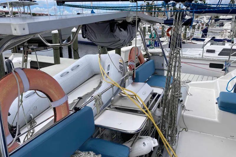 Stimulus Package Yacht Photos Pics 2009 Seawind 36 1000XL catamaran with lifebuoys, seating, and docked sailboats in marina.