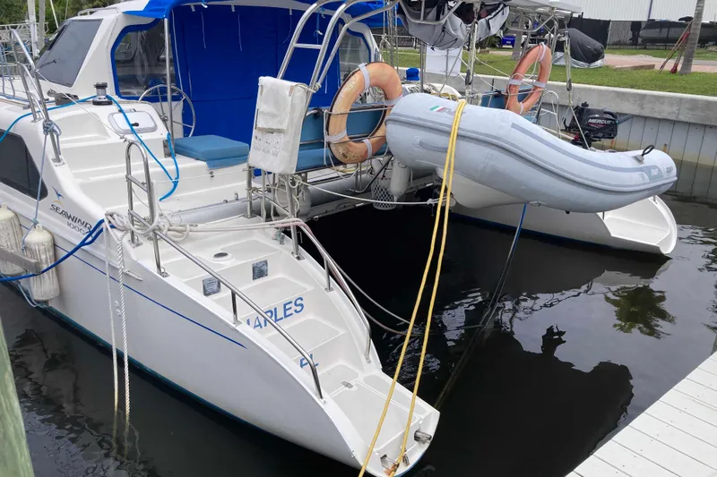 Stimulus Package Yacht Photos Pics 2009 Seawind 36 1000XL catamaran docked with inflatable dinghy and safety equipment.