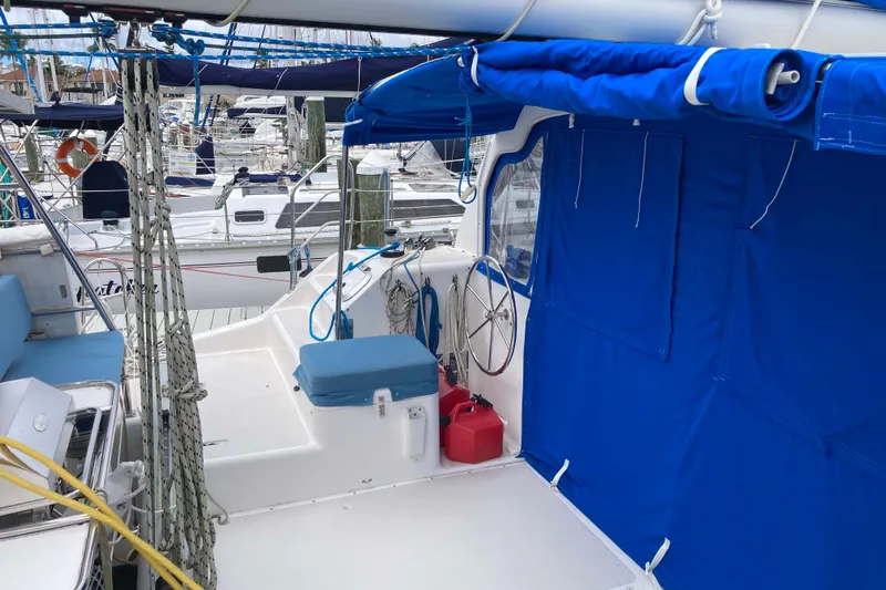 Stimulus Package Yacht Photos Pics 2009 Seawind 36 1000XL catamaran with blue canopy and marina background.