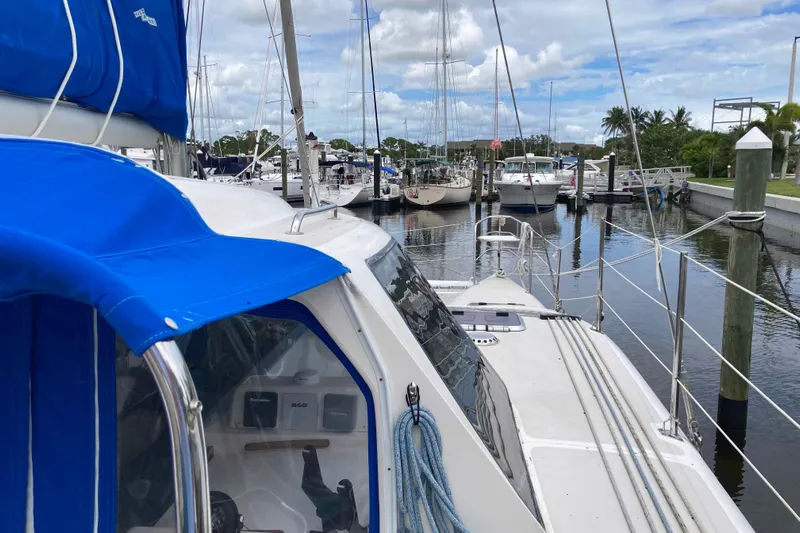 Stimulus Package Yacht Photos Pics 2009 Seawind 36 1000XL catamaran docked in a marina with blue canopy.