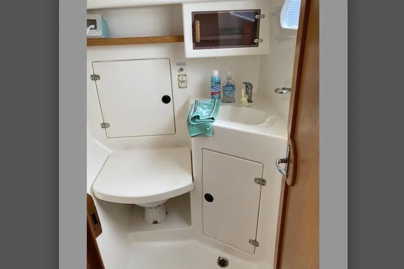 Stimulus Package Yacht Photos Pics 2009 Seawind 36 1000XL yacht bathroom with sink, storage, and toiletries.