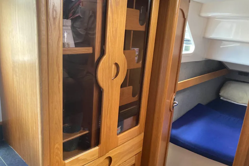 Stimulus Package Yacht Photos Pics Interior of 2009 Seawind 36 1000XL yacht with wooden cabinetry and cozy sleeping area.