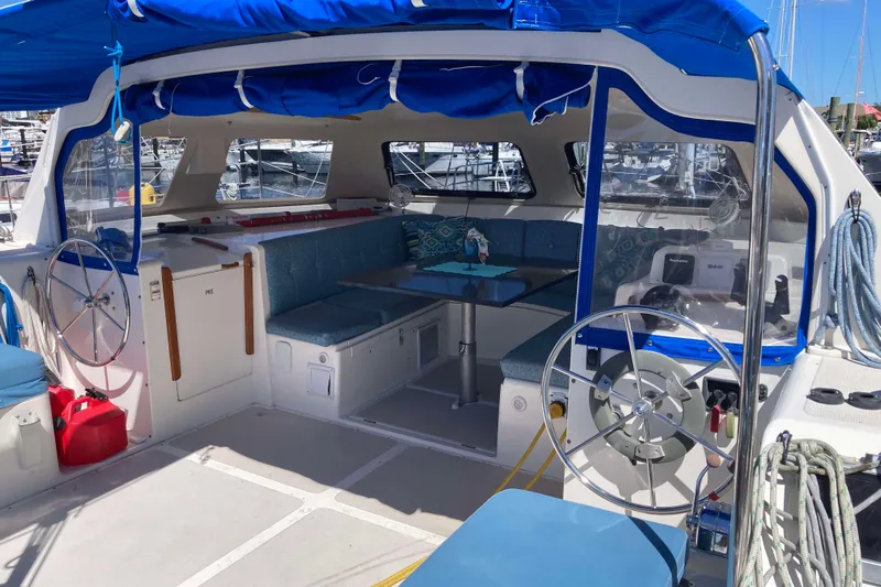 Stimulus Package Yacht Photos Pics 2009 Seawind 36 1000XL catamaran interior with blue seating and dual steering wheels.