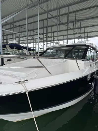  Yacht Photos Pics 2023 Regal 36 Grande Coupe boat docked under a covered marina.