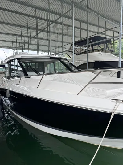  Yacht Photos Pics 2023 Regal 36 Grande Coupe docked under a covered marina.