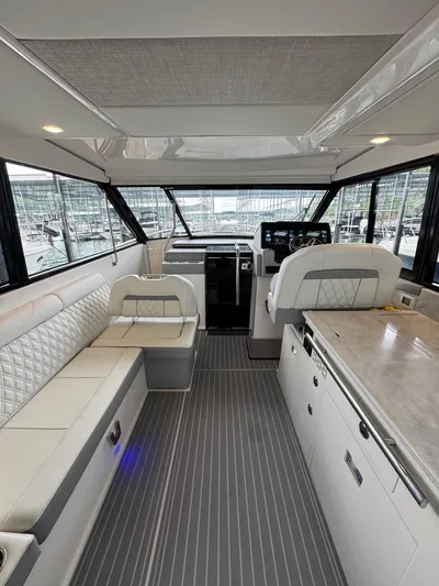  Yacht Photos Pics Interior of 2023 Regal 36 Grande Coupe yacht, featuring luxurious seating and modern helm.