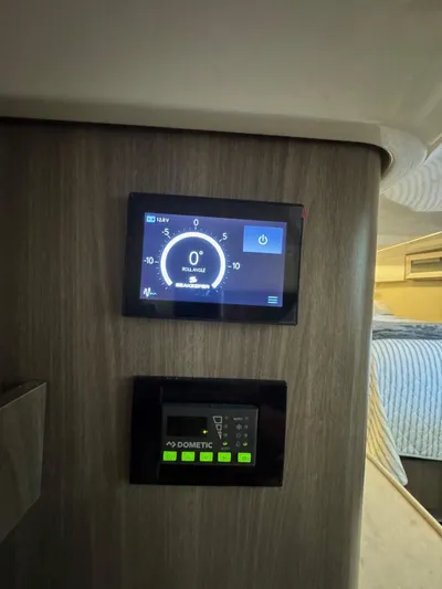 Yacht Photos Pics Control panel inside 2023 Regal 36 Grande Coupe, featuring digital displays and settings.