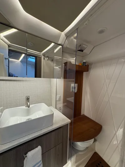  Yacht Photos Pics Luxurious bathroom in 2023 Regal 36 Grande Coupe yacht with modern fixtures and elegant design.