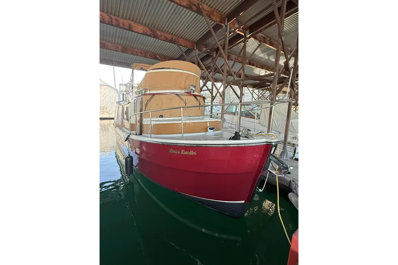  Yacht Photos Pics 2016 Ranger Tugs R-31 CB boat docked under a metal roof.
