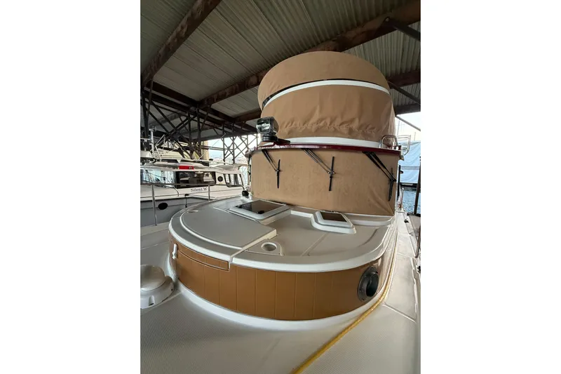  Yacht Photos Pics 2016 Ranger Tugs R-31 CB boat under a covered dock, showcasing its deck and structure.