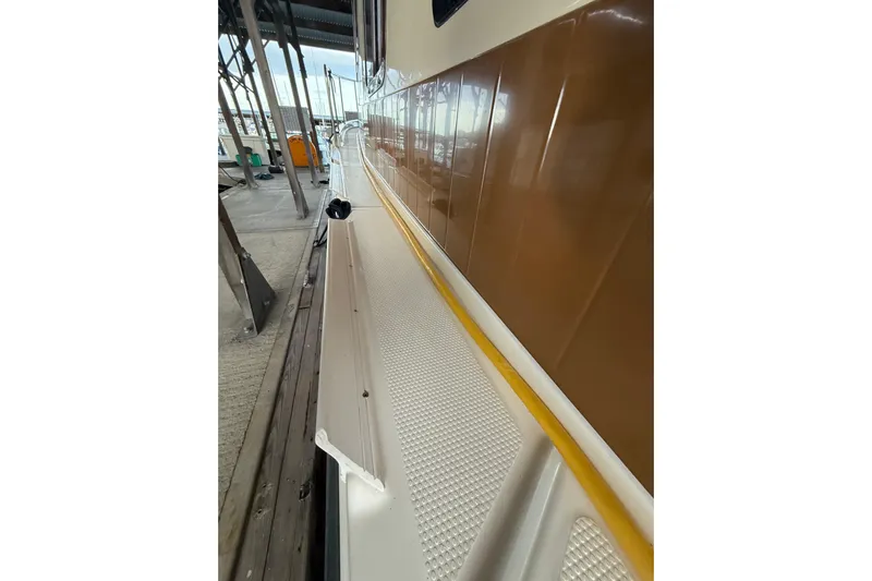  Yacht Photos Pics 2016 Ranger Tugs R-31 CB boat deck with brown exterior in marina.