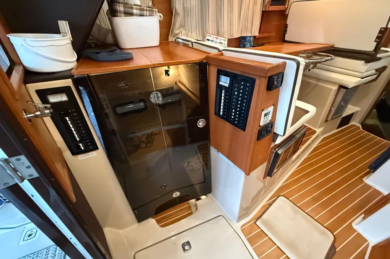  Yacht Photos Pics 2016 Ranger Tugs R-31 CB interior with control panels and wooden flooring.