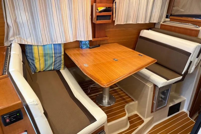  Yacht Photos Pics 2016 Ranger Tugs R-31 CB interior with cozy dining area and striped cushions.