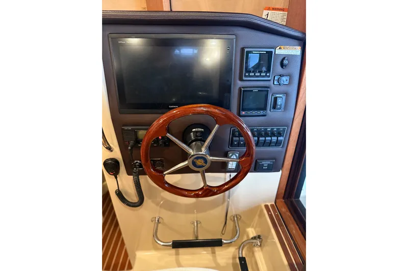  Yacht Photos Pics 2016 Ranger Tugs R-31 CB helm with wooden steering wheel and navigation controls.