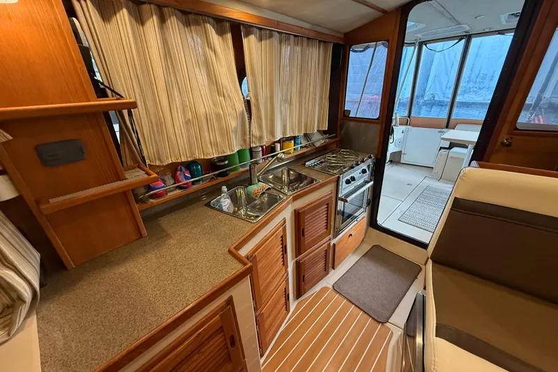  Yacht Photos Pics 2016 Ranger Tugs R-31 CB interior kitchen with stove, sink, and seating area.