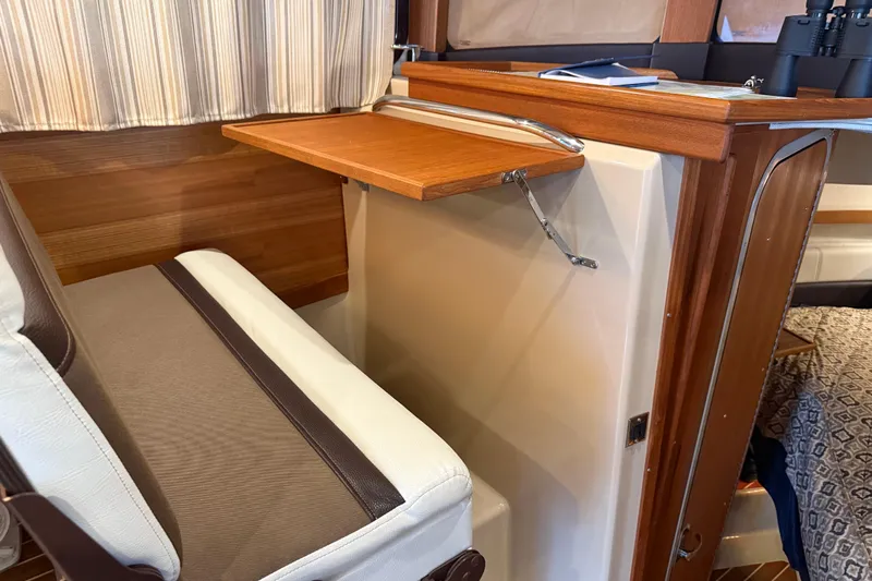  Yacht Photos Pics Interior of 2016 Ranger Tugs R-31 CB with foldable wooden table and cushioned seating.