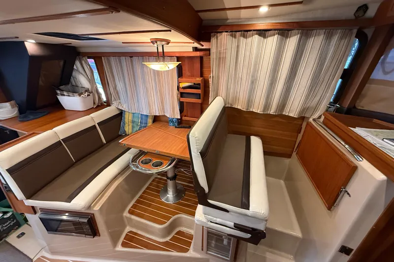  Yacht Photos Pics 2016 Ranger Tugs R-31 CB interior with cozy dining area and striped curtains.