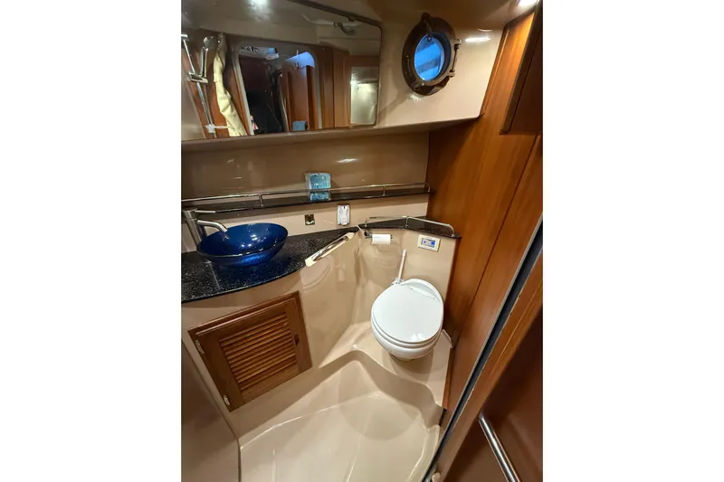  Yacht Photos Pics 2016 Ranger Tugs R-31 CB bathroom with modern sink, toilet, and porthole window.