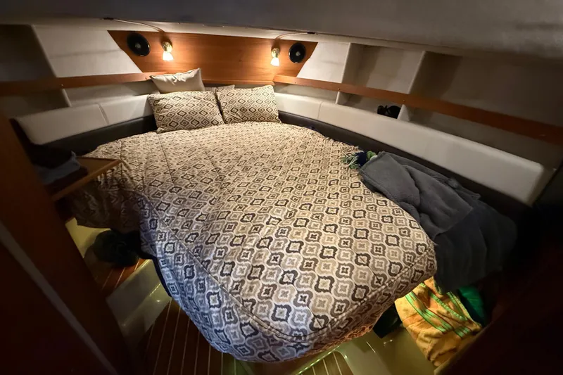 Yacht Photos Pics Cozy cabin interior of 2016 Ranger Tugs R-31 CB with patterned bedding and ambient lighting.