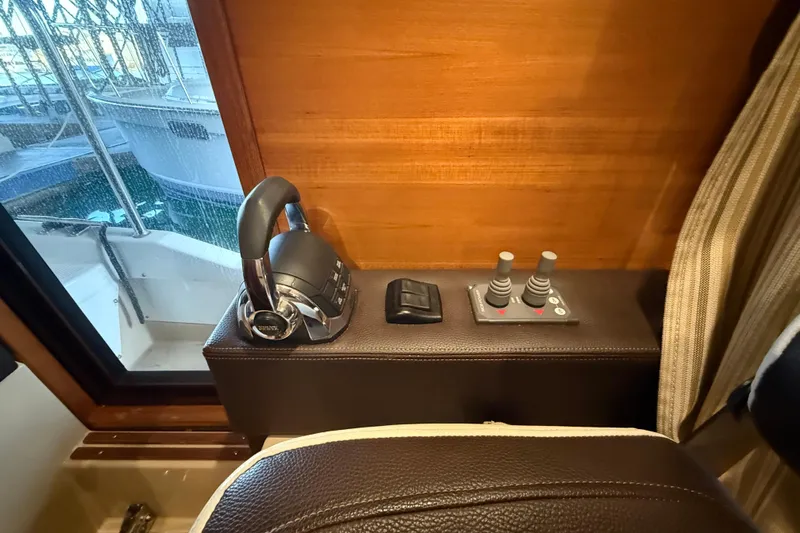  Yacht Photos Pics Interior helm controls of 2016 Ranger Tugs R-31 CB boat, featuring throttle and joystick.