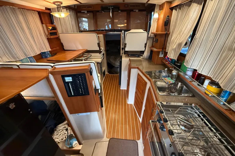  Yacht Photos Pics 2016 Ranger Tugs R-31 CB interior with kitchen, dining area, and wood accents.