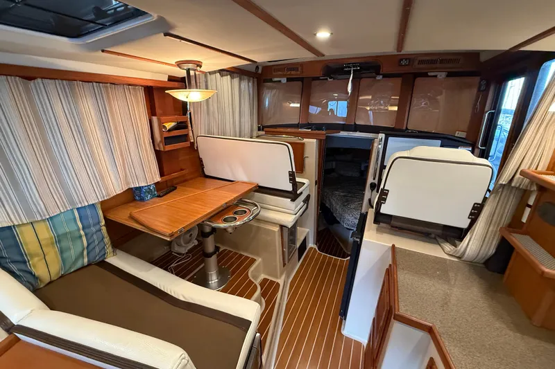  Yacht Photos Pics Interior of 2016 Ranger Tugs R-31 CB with cozy seating and wooden accents.
