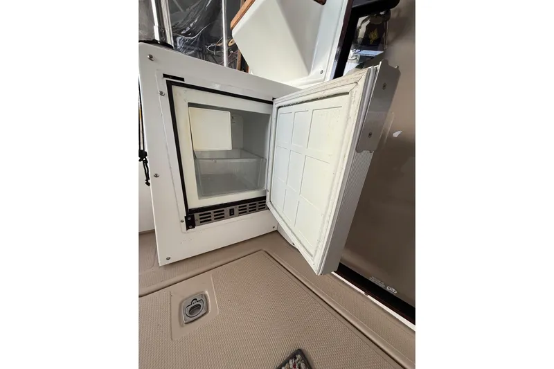 Yacht Photos Pics Open refrigerator on 2016 Ranger Tugs R-31 CB boat, showing interior storage space.