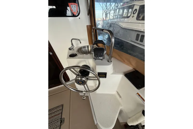  Yacht Photos Pics 2016 Ranger Tugs R-31 CB helm with steering wheel and sink.